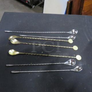 Assorted Swizzel Spoons, six pieces, silver and gold tones, twisted handles, round end medallions, good condition.