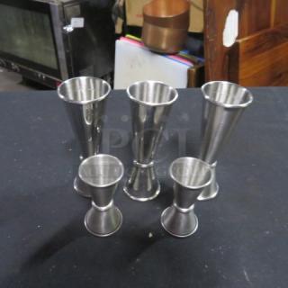 Assorted stainless steel jiggers, set of five. Includes various sizes. Polished finish, good condition. Perfect for bartending.