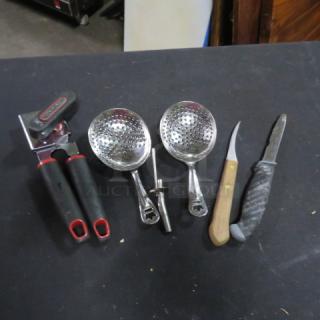 Assorted kitchen utensils, including a manual can opener, two slotted ladles, and two knives with wood and textured grips.