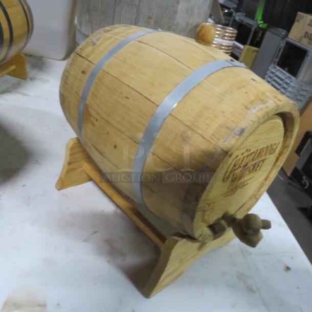 Chattanooga wooden whiskey barrel on stand, featuring metal hoops, spigot, and logo engraving. Great condition.