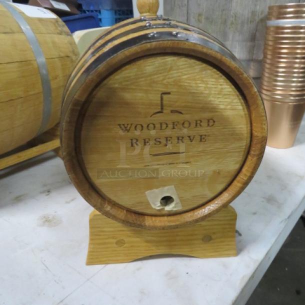 Woodford Reserve wooden whiskey barrel on a stand, features branded logo, in good condition.