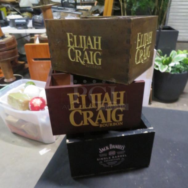 Assorted wooden bar organizers, featuring Elijah Craig and Jack Daniel's branding, in used condition. Perfect for bars.
