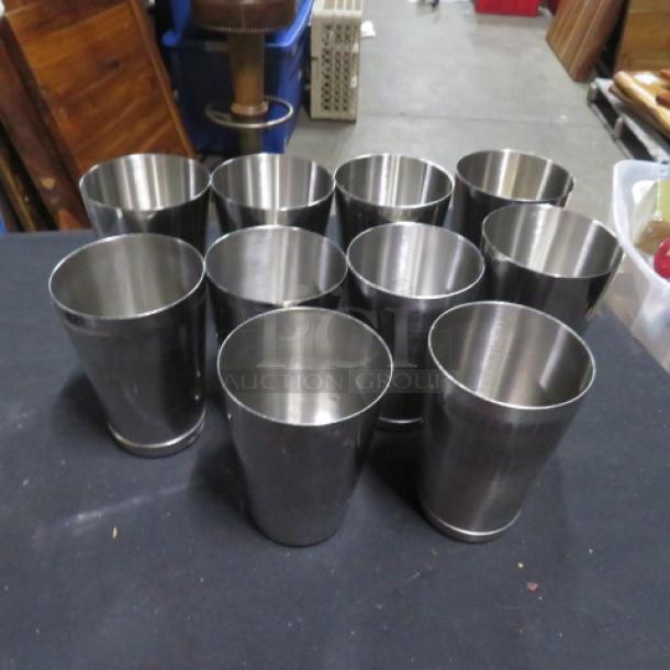Set of 10 stainless steel mixing glasses, polished finish, excellent condition, ideal for bar or kitchen use.