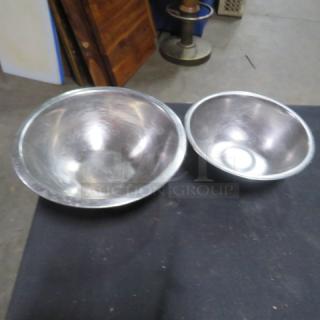 Assorted stainless steel mixing bowls, two sizes, slightly used condition, reflective finish, ideal for kitchen prep.