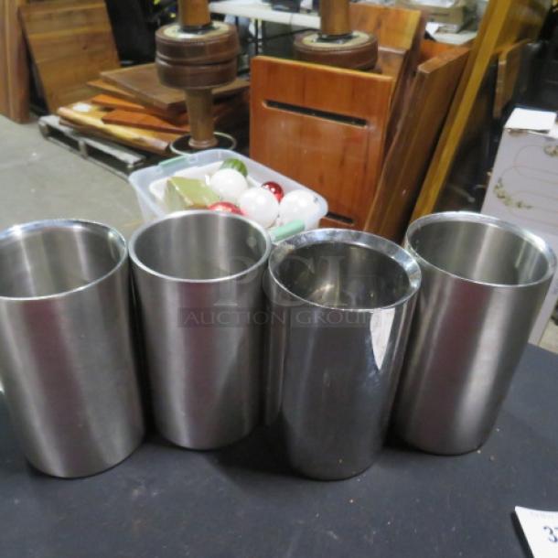 Four stainless steel wine/champagne holders in good condition, cylindrical design, ideal for entertaining.