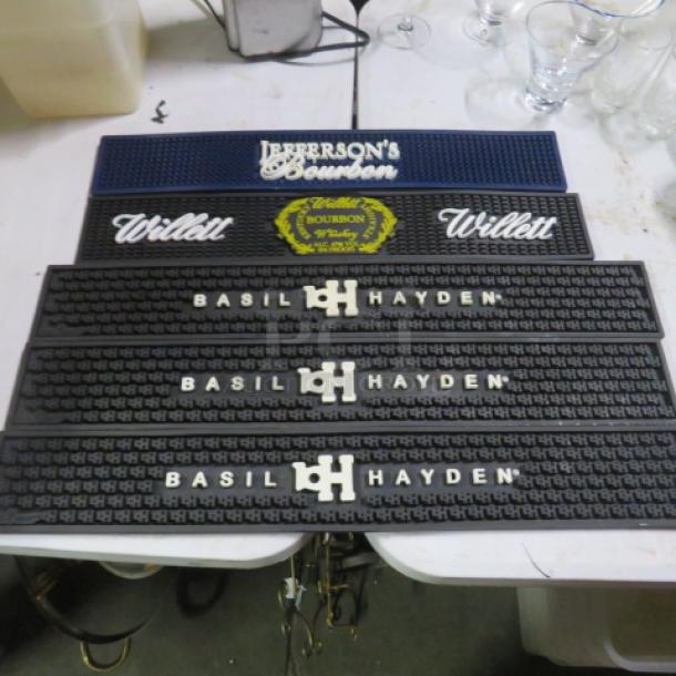 Assorted bar mats featuring Jefferson's Bourbon, Willett, and Basil Hayden logos in good condition.