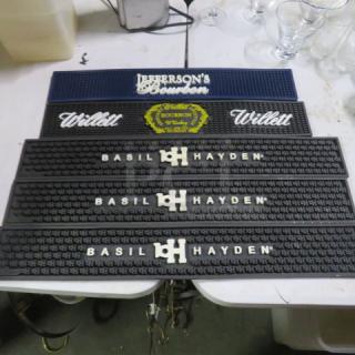 Assorted bar mats featuring Jefferson's Bourbon, Willett, and Basil Hayden logos in good condition.