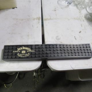 Jack Daniels Single Barrel bar mat, black rubber, embossed logo, rectangular design, used condition, some surface wear.