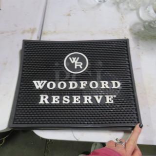 Woodford Reserve bar mat, black with logo and text, rectangular, rubber material, in good condition.