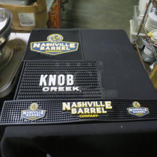 Assorted bar mats featuring Nashville Barrel Company and Knob Creek designs. Black rubber with logos in good condition.