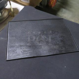Black Bar Mat 3XBID, rectangular rubber with textured surface. Used for spill management. Appears in good condition.