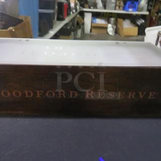 Woodford Reserve wooden domed bar center, featuring engraved branding. Appears in good condition with a dark wood finish.