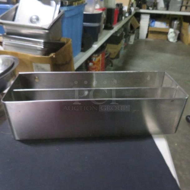 Stainless steel dual bottle rail, 23.5x8x6 inches, in good condition. Ideal for bar storage or organization.