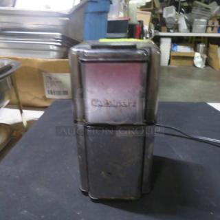 Cuisinart DCG-12BC coffee grinder in fair condition. Visible branding on front. Electric cord attached.