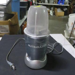 Nutri Bullet blender model NB101B in good condition, features include a power cord and blending cup with lid.
