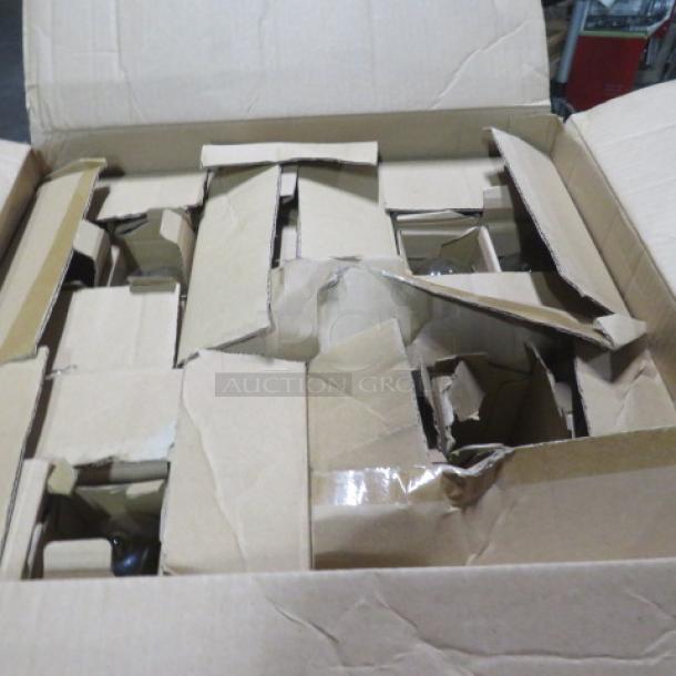 Box containing a lot of light bulbs, in original packaging, visible wear on cardboard, bulbs appear new and unused.
