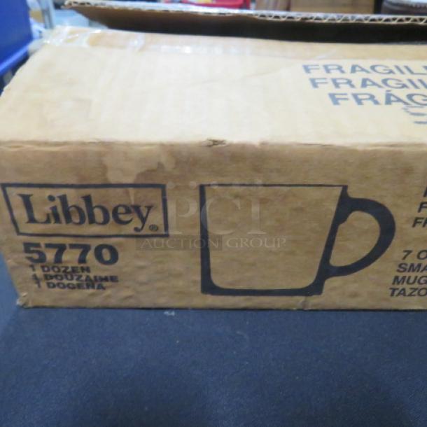 New Libbey 7oz glass mugs, model 5770, in unopened box labeled "1 dozen," indicating quantity.