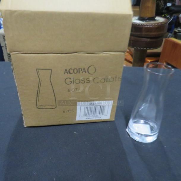 NEW Acopia 6oz glass carafe next to original box. Box labeled "Acopa Glass Carafe 6 oz, Made in China, 6/CS."