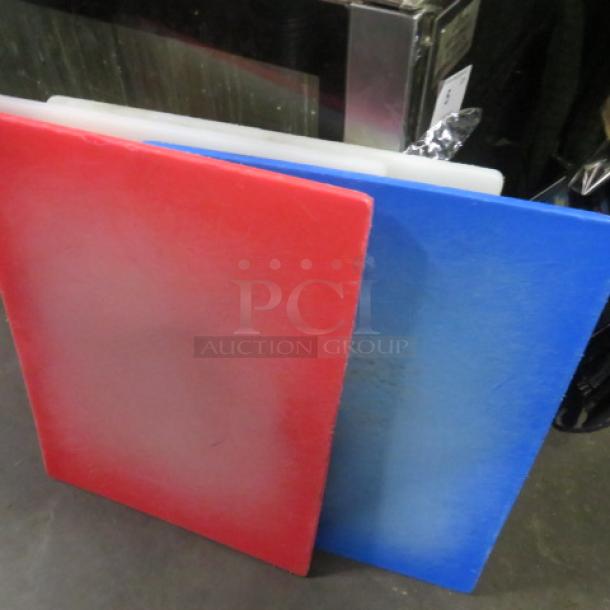 Assorted color 18x24 cutting boards, red and blue shown. Durable, lightly used, ideal for kitchen prep. Model 4XBID.