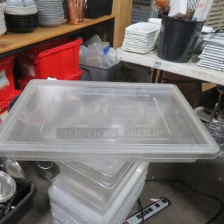 Clear 5-gallon food storage container with lid; stackable, durable plastic, ideal for bulk storage.
