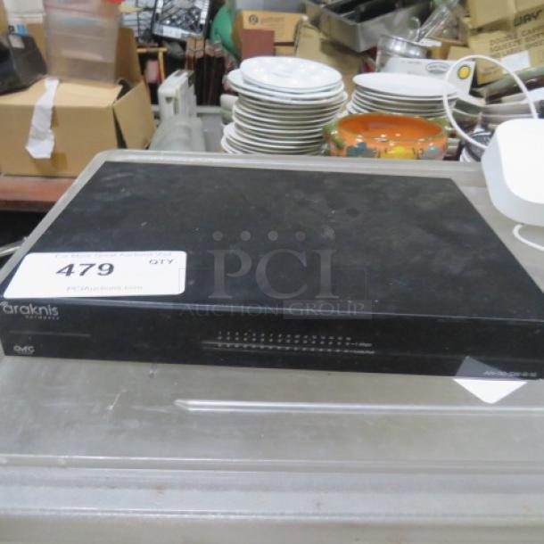 Araknis Gigabit Switch #AN-110-SW-R-16, featuring multiple ports, in used condition on auction display table.