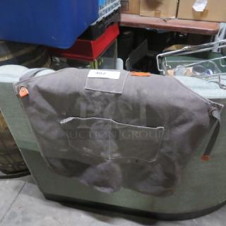 Heavy-duty dishwasher apron, gray fabric, with front pocket and adjustable straps. Tag marked "482" on top.