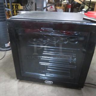 Sunbeam Wine Cooler WCSB50, black, 19x19x18 inches, 115V, used condition with visible interior storage racks and clear front door.