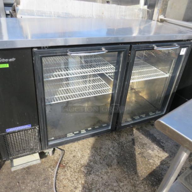 Turbo Air glass door back bar cooler, model TBB-24-60SGN, with 3 racks, on casters, in working condition. Dimensions 61x24x38.5.