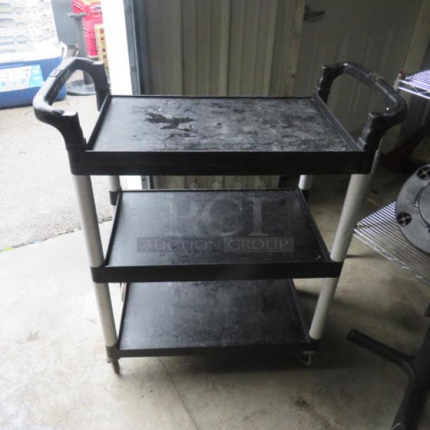 Three-shelf poly cart on casters, black, 32.5x16x38 inches, used condition with scuff marks, sturdy handles, ideal for storage.