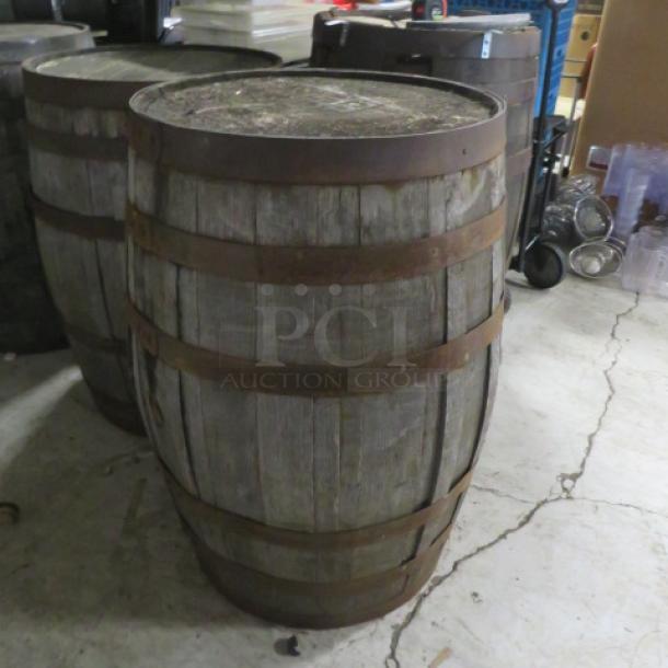 Old Forester whiskey barrel, weathered wood with metal bands, used condition, ideal for collection or decor.