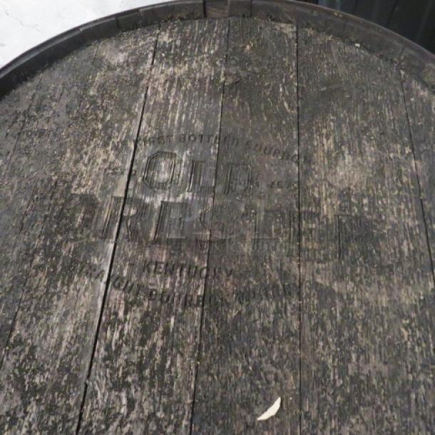 Old Forester whiskey barrel with visible branding. Weathered wood, intact metal bands. Collectible condition.