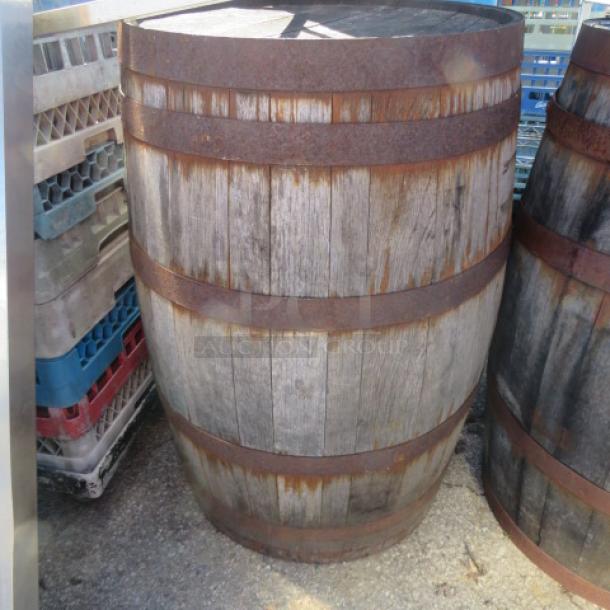 Aged wooden whiskey barrel with iron bands, rustic condition, suitable for decor or restoration.