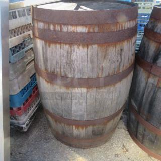 Aged wooden whiskey barrel with iron bands, rustic condition, suitable for decor or restoration.