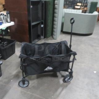 Ozark Trail folding cart, black fabric, sturdy metal frame, large wheels, extended handle, used condition.