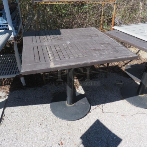 Brown patio table, square, 36x36x30 inches, slatted top, metal pedestal base. Good condition, outdoor use.
