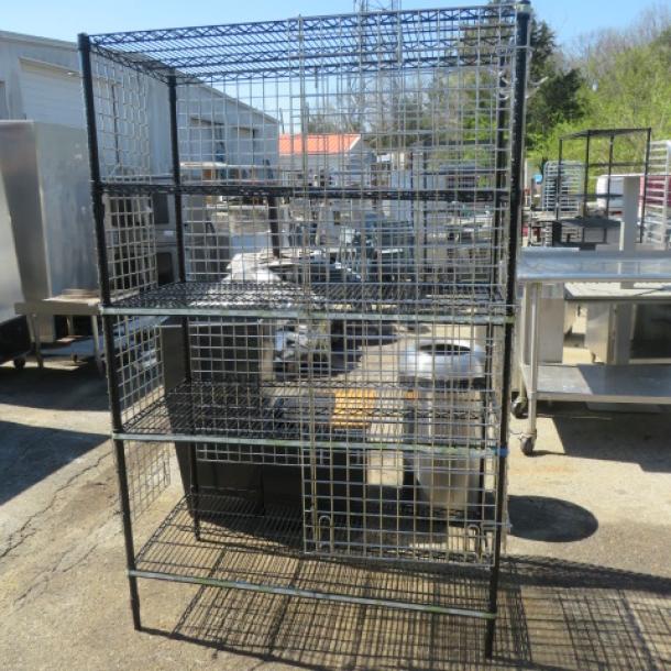 Black Metro liquor cage, 5 shelves, silver sides, back, door. Dimensions: 48x24x74 inches. Sturdy, secure storage unit.