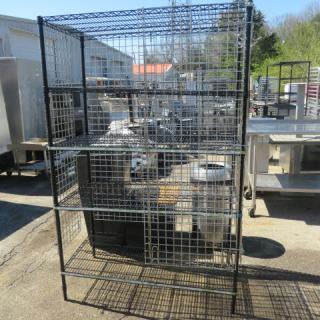 Black Metro liquor cage, 5 shelves, silver sides, back, door. Dimensions: 48x24x74 inches. Sturdy, secure storage unit.