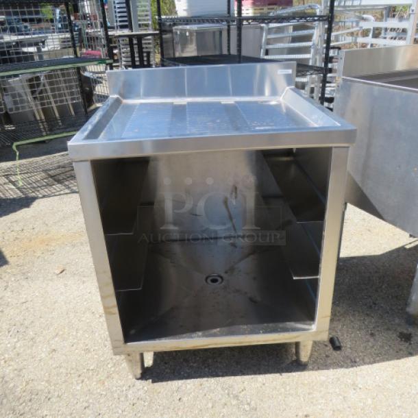 Advance Tabco stainless steel under bar drain table, model CRCR-24, with dishrack storage, 24x21x33 inches, new condition.
