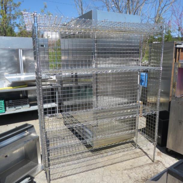 Silver Metro shelf/cage with 1 door, 4 shelves, 60x18x75 inches, in good condition. Perfect for storage and organization.