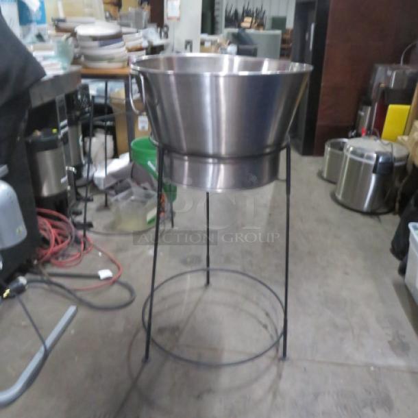 Black wire frame holder with stainless steel beverage bucket, ideal for parties, features sturdy construction, excellent condition.