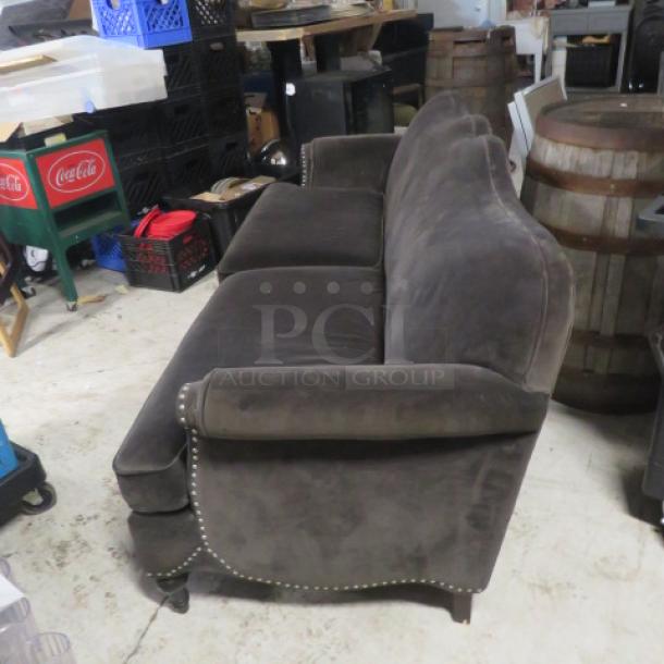 Brown velvet cushioned couch, 80x35x35, features nailhead trim, in good condition, elegant and plush design.