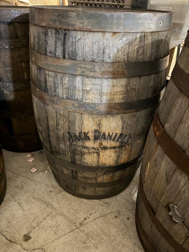 Jack Daniels whiskey barrel, stamped "Operation Ride Home," shows moderate wear, wood construction, visible branding.