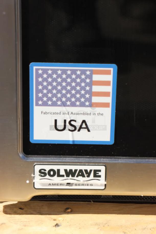Brand new Solwave Ameri-Series SWA12T microwave, stainless steel, 1,200W, push button controls, superficial denting, USA-made label.