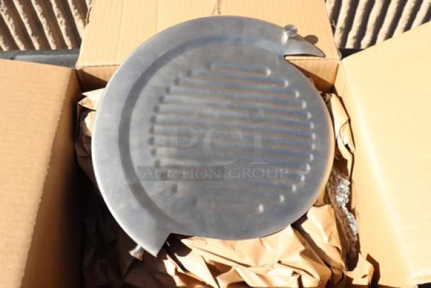 Brand new meat slicer component with minor scratches, visible in open box. Circular metal part with ridged surface.