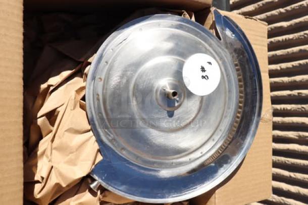 Brand new metal meat slicer component, scratch and dent condition, in a cardboard box with protective paper.