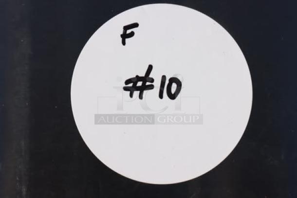 White sticker with handwritten "F #10" on black background, possibly a lot or inventory number.
