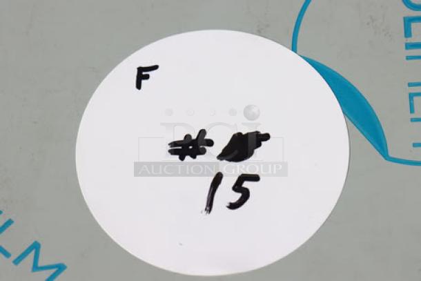 White circle with handwritten black text, numbers, and markings, including "F" and "# 15."