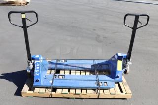 Two blue Lavex 27"x48" manual pallet jacks, 6600 lb capacity each, shown secured on a pallet. Brand visible on the frame.