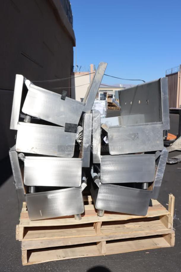 Regency 600HSMS1848 hand sinks stacked on a pallet. Missing wall mounting hardware, may have scratches and dents.