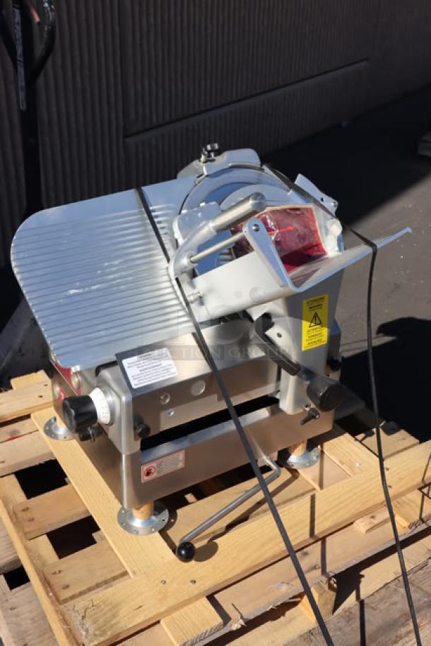 Estella SLA13 13" heavy-duty automatic meat slicer on pallet, new with scratch-and-dent condition, 3/4 hp, 120V.